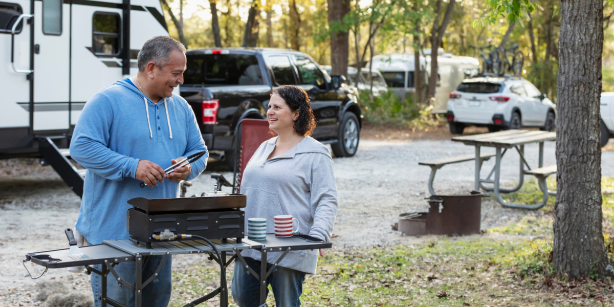 a couple camping with their RV at a campground wondering if their RV insurance covers mold
